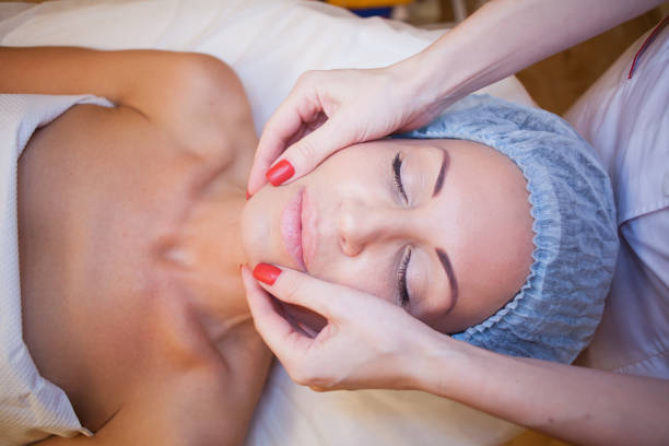 istock doctor cosmetologist doing facial massage girl Spa 817358708
