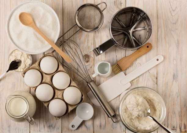 istock Kitchen utensils and tools for homemade baking on a light wooden background. 817361786