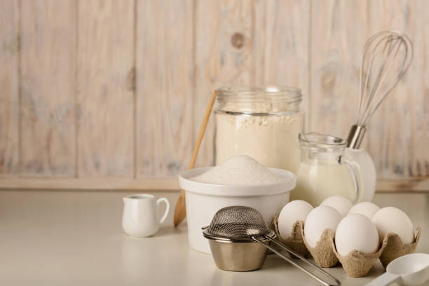 istock Kitchen utensils and tools for homemade baking on a light wooden background. 817361790