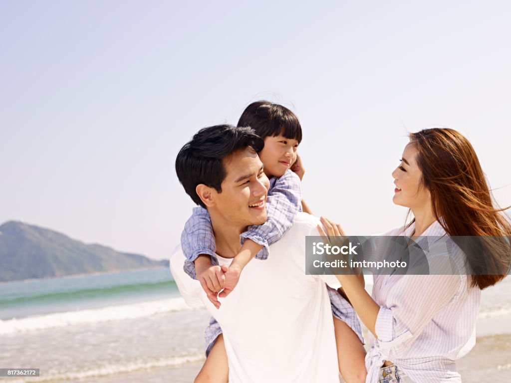 happy asian family having fun on beach happy asian family vacationing on beach. Family Stock Photo