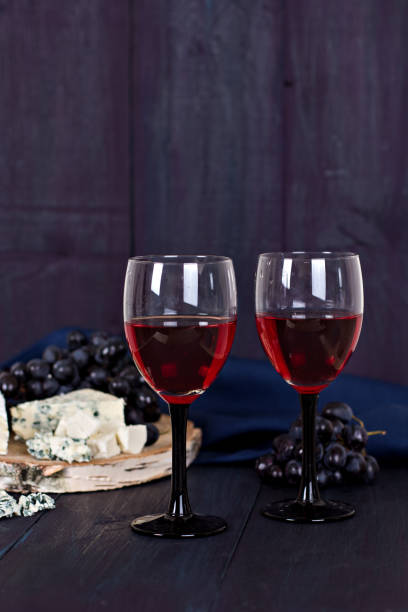 istock Red wine and snacks. Wine, grapes, cheese, nuts, olives. Romantic evening, still life. 817367236