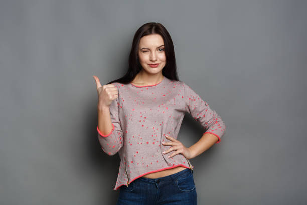 istock Young beautiful woman with thumb up portrait 817367586