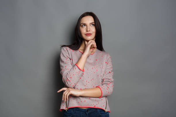 istock Pensive young woman looking upwards 817367618