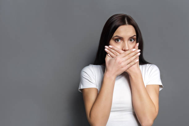istock Scared woman covering mouth with hands 817368070