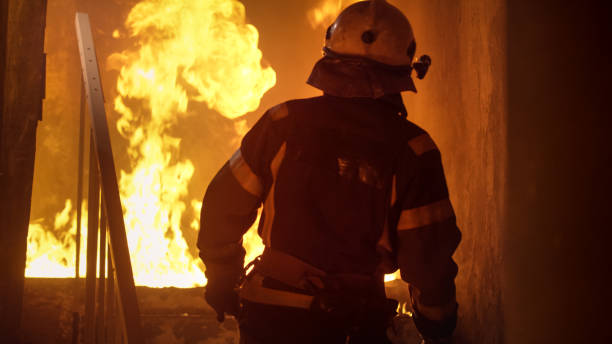 istock Building is On Fire. Fireman is Going Upstairs. Open Flames are Seen on Stairs. 817388406