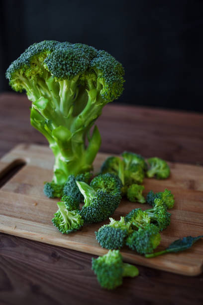 istock Fresh broccoli. Many green broccoli on a wooden table. Close-up 817388782