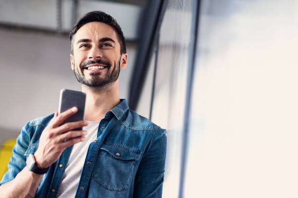 Hilarious smiling man keeping phone