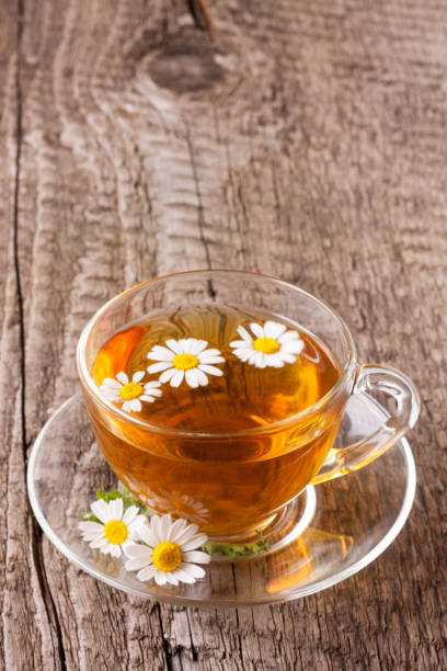 istock Herbal tea with fresh chamomile flowers on old wooden background with copy space for your text 817388876