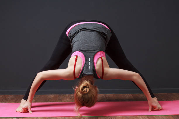 istock Deep bend with straddled legs. Woman doing workout 817391300