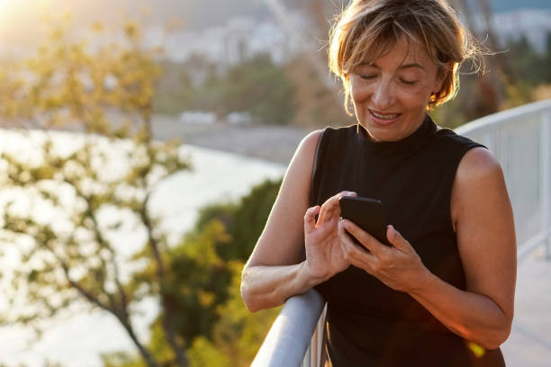 istock Mature  woman using mobile phone 817392376