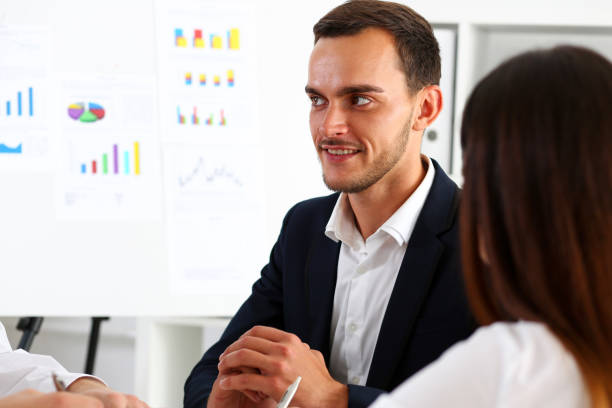istock Group of people deliberate on white board problem 817392874