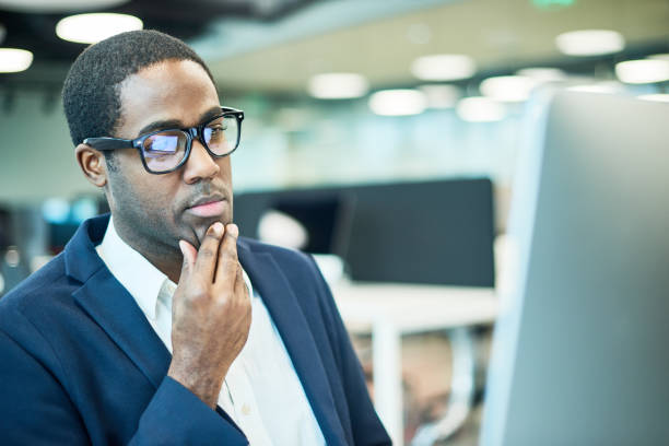 istock African Businessman Wearing Glasses Thinking about Work Issues 817401374
