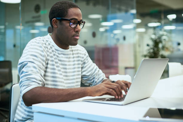 istock African Young Man Using Laptop in Office 817401688