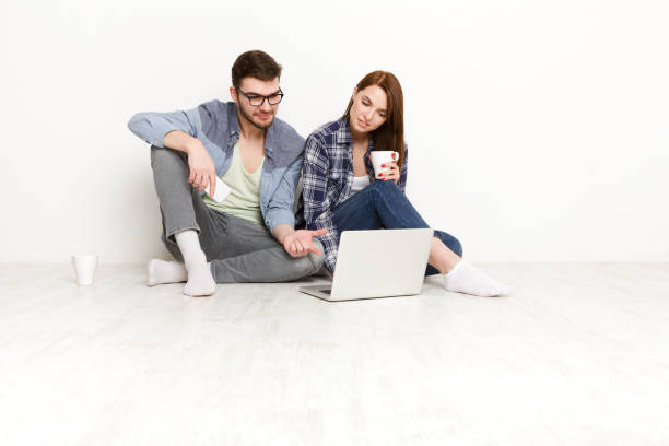istock Casual couple working with laptop, studio shot 817402690