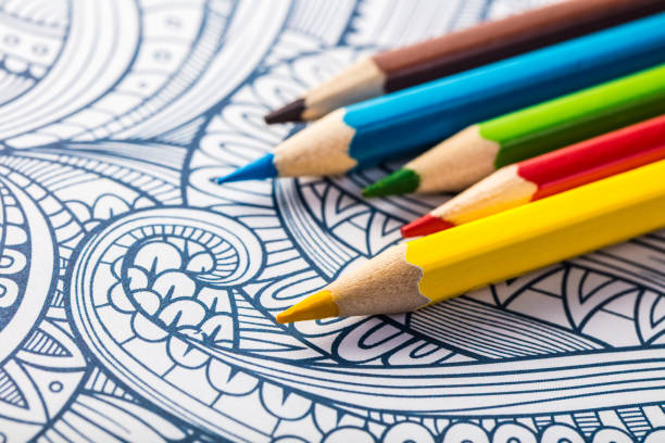 Colored wooden pencils close-up on a coloring background