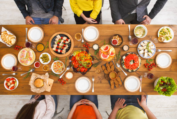 istock People eat healthy meals at served table dinner party 817409416