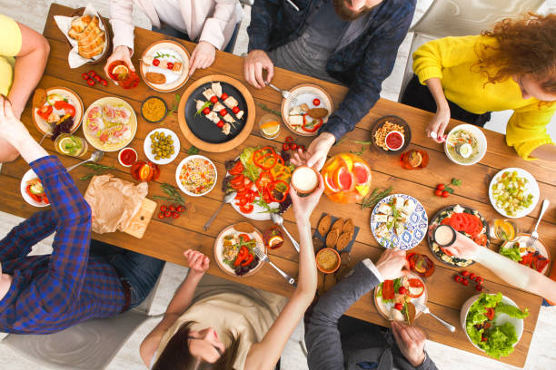 istock People eat healthy meals at served table dinner party 817409578