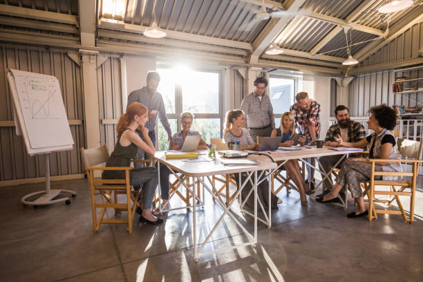 istock Large group of multi-tasking entrepreneurs working in a modern office. 817409812