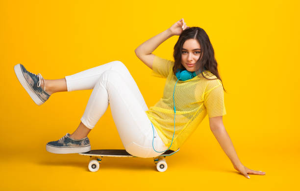 istock Girl sitting on cruiser leaning on floor 817409954