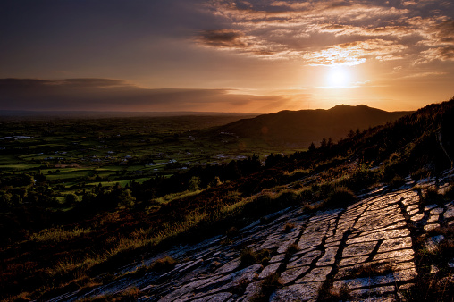 Just before the last reflection of light on those eroded stones above the going to sleep quiet Irish plain, Croslieve, Slieve Gullion, County Down, Northern Ireland, United Kingdom