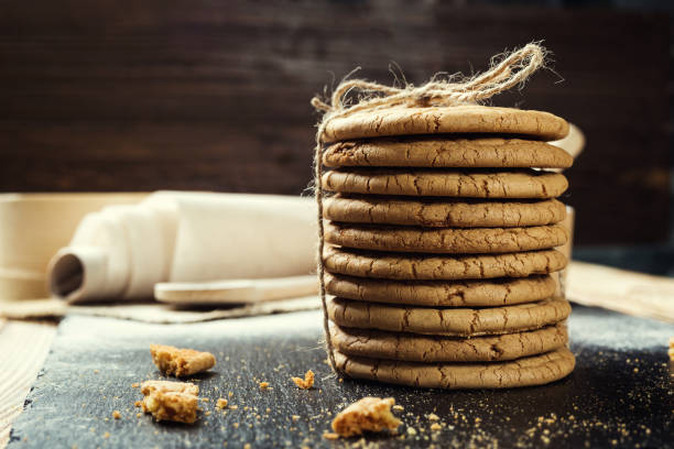 istock Biscuit sweet cookie background. Domestic stacked butter biscuit pattern concept,close up macro.Homemade cookies on wooden table.Cereal biscuits with the sesame,peanuts,sunflower and amaranth. 817426732