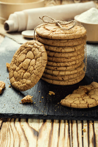 istock Biscuit sweet cookie background. Domestic stacked butter biscuit pattern concept,close up macro.Homemade cookies on wooden table.Cereal biscuits with the sesame,peanuts,sunflower and amaranth. 817428864