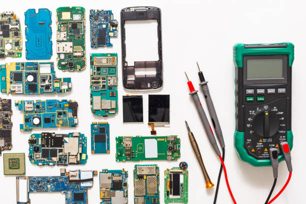 istock Multimeter and broken mobile electronics at repair shop 817431008