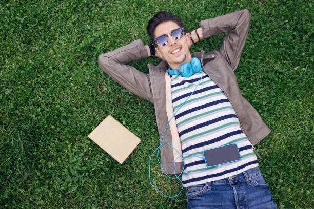 istock Man chilling out on the green grass 817432092