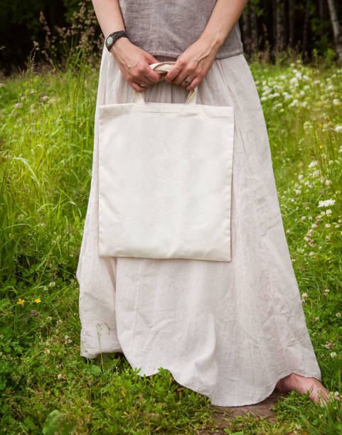 istock Woman holding empty linen bag. Template mock up 817432196