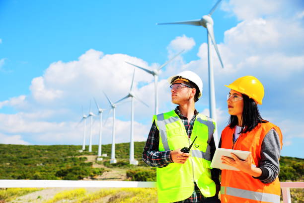 Windmills and Workers Windmills and Workers. çevre stock pictures, royalty-free photos & images