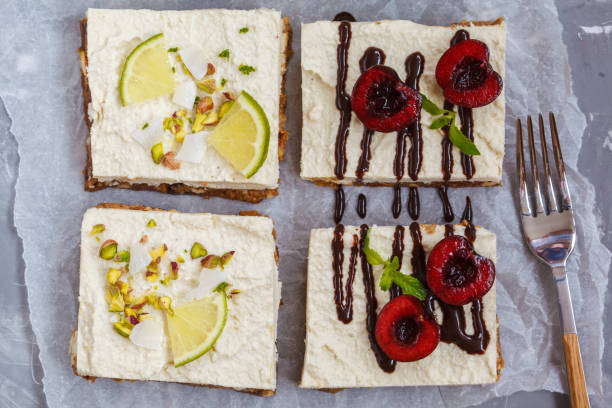 istock Raw pistachio, coconut, lime and chocolate-cherry cheesecakes 817437036