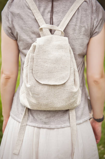 istock Woman holding linen backpack bag. Template mock up 817437484