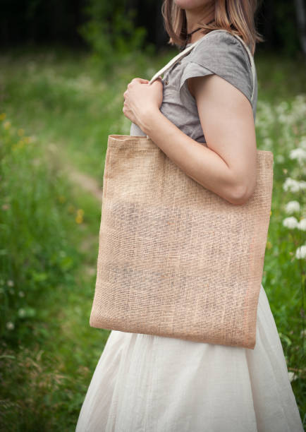 istock Woman holding empty linen bag. Template mock up 817437670