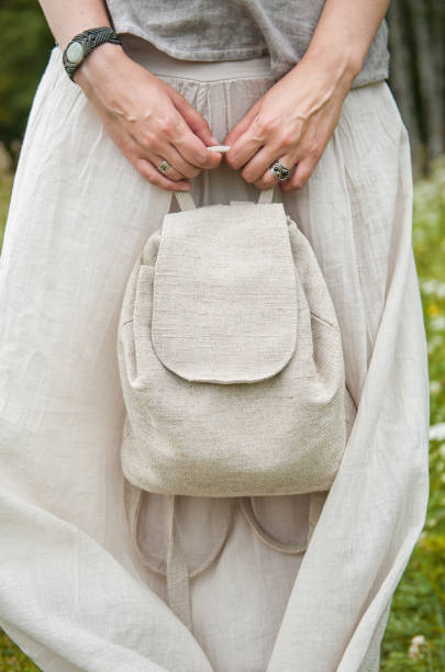 istock Woman holding empty linen backpack. Template mock up 817442130