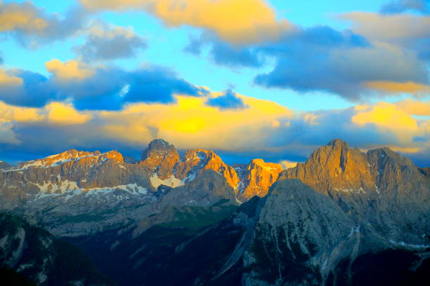istock Above Idyllic Sas Pordoi and Passo Sella, Langkofel pinnacle massif mountain range front view at dramatic gold colored sunset sky, dramatic panorama and majestic Dolomites, Italy tirol alps 817442398