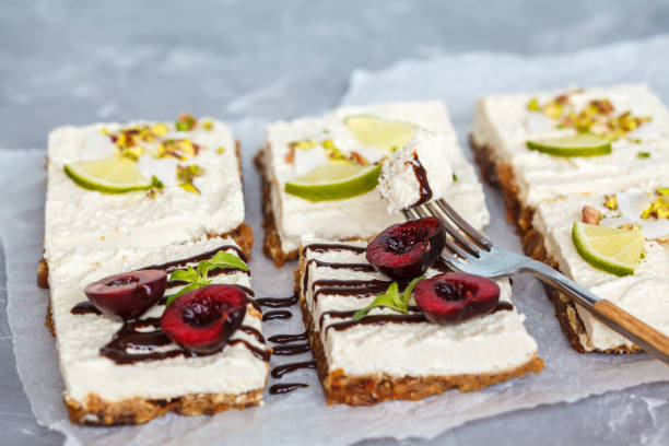 istock Raw pistachio, coconut, lime and chocolate-cherry cheesecakes 817443674