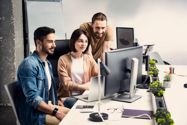 istock Cheerful partners looking at monitor 817443752