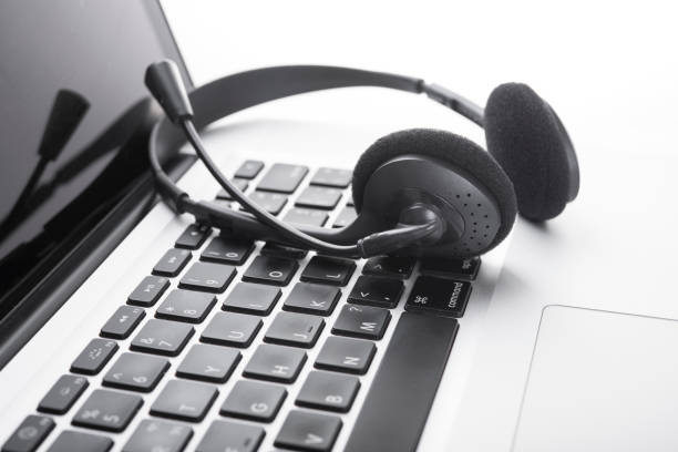 istock headset and computer laptop, call center support and customer service help, concept for communication 817451582