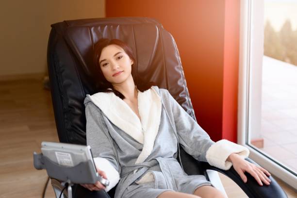 istock Young woman relaxing on the massaging chair 817455182