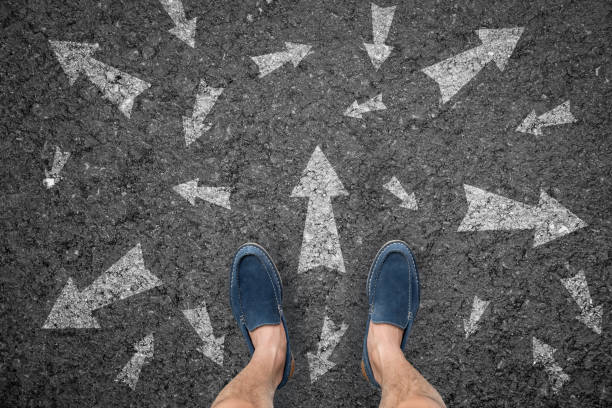 istock man standing on road with many direction arrow choices or move forward. concept solution and start. 817455968