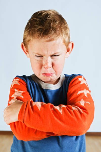 istock Scowling pre-school boy with folded arms has a tantrum 817466334