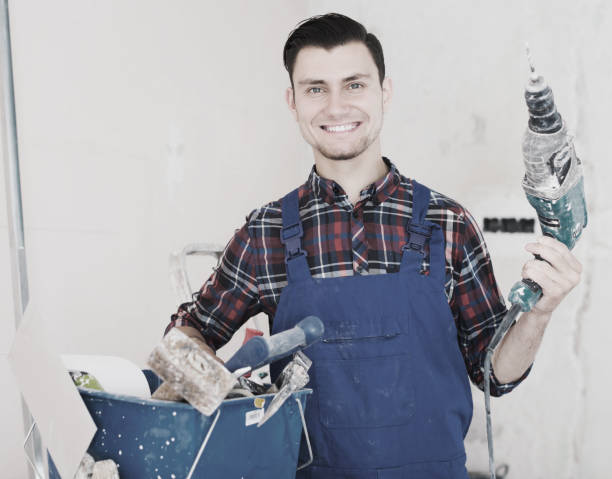 istock Portrait of builder handyman with electric drill 817468848