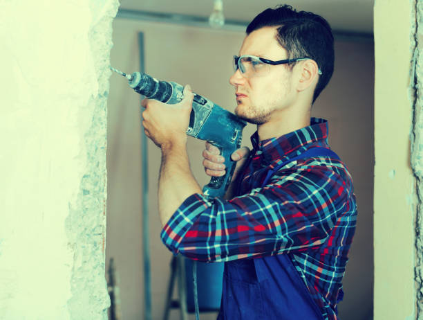 istock Builder handyman with electric drill indoors 817469344