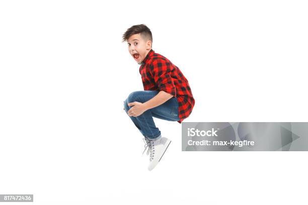 Cheerful Jumping Boy Stock Photo - Download Image Now - Child, Jumping, Boys