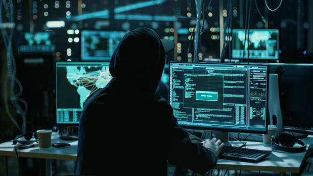 istock Teenage Hacker Working with His Computer Infecting Servers and Infrastructure with Malware. His Hideout is Dark, Neon Lit and Has Multiple displays. 817486178
