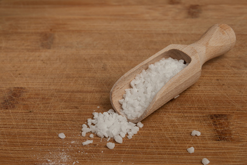 Thick sea salt on a wooden spoon for spices