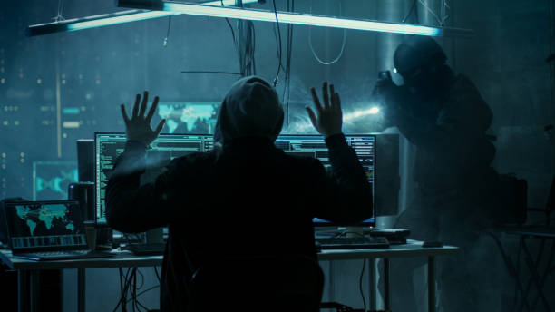Fully Armed Special Cybersecurity Forces Soldier Arrests Highly Dangerous Hacker. Hideout is Dark and Full of Computer Equipment.
