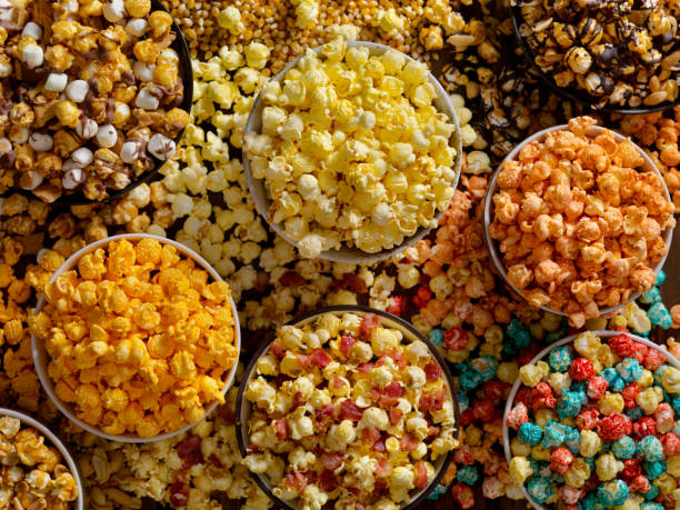 Favorite popcorn toppings, from maple bacon to Hot and Spicy Favorite popcorn toppings, Butter, Cheddar, Smores, Caramel, Candied, Hot and Spicy and Chocolate Peanut popcorn stock pictures, royalty-free photos & images