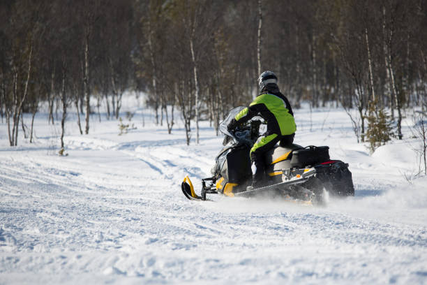 istock Woman driving snow mobile 817508980