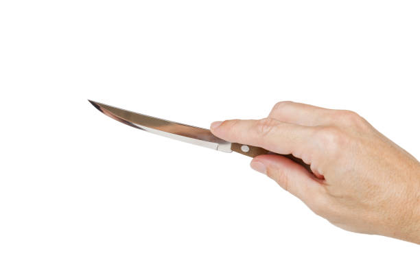 istock Humans hand holding a silver knife 817513550